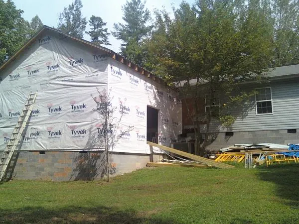 Tyvek wrapped gable on a new room addition beside an existing home in Feeding Hills